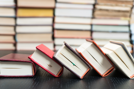 Stack books on wooden background. Back to school with copy space.の写真素材