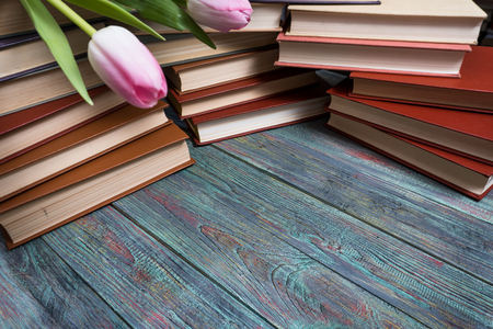 Pink tulips with books on wooden background with copy spaceの写真素材