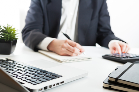 Close up view of bookkeeper or financial inspector hands making report, calculating or checking balance. Marketing strategy brainstorming. Paperwork and digital in office.の写真素材