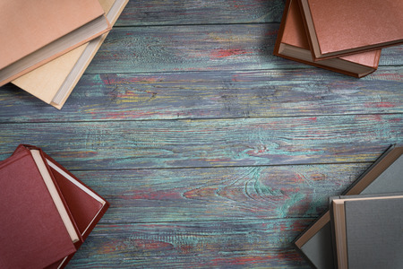A lot of books on a colored wooden background with copy space.の写真素材