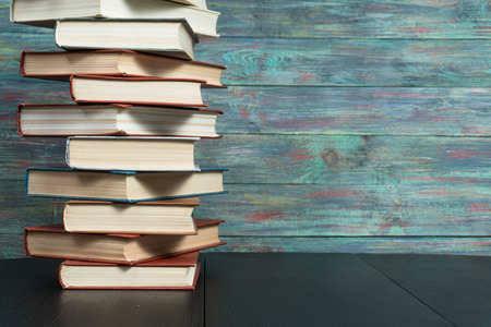 Stack books on wooden background. Back to school with copy space.の写真素材
