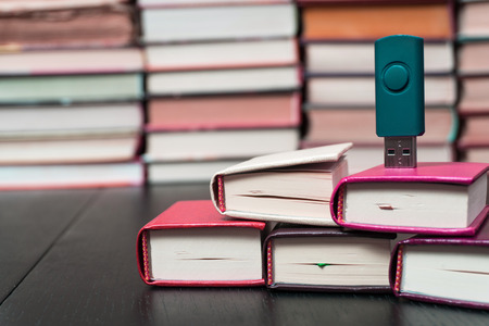 Memorization of knowledge books and organizer are near the blue stick on the table symbolizing. Stack books on wooden background. Back to school with copy space.の写真素材