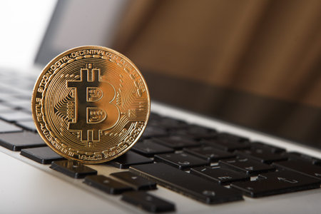 Golden Bitcoin - New virtual money on notebook. A visual representation of digital cryptocurrencies....