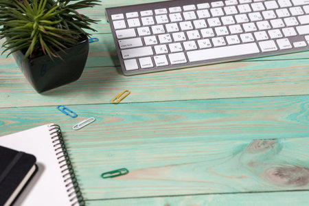 Blue office desk table with with office supplies. Top view with copy spaceの写真素材