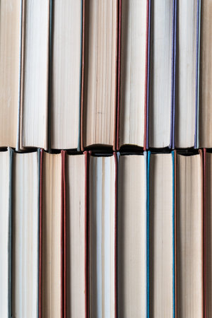Many books in a bookstore or library on wooden background with copy space