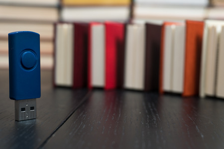 Memorization of knowledge books and organizer are near the blue stick on the table symbolizing. Stack books on wooden background. Back to school with copy space.の写真素材