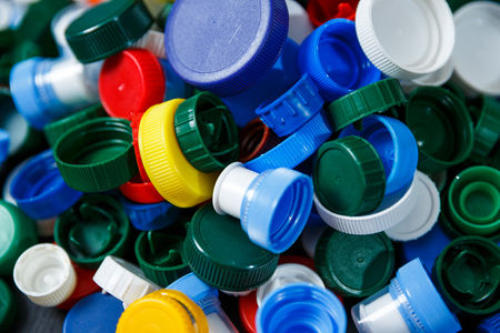Conception of plastic processing for ecology or charity. Collection of various colorful plastic screw caps. Useful as backgroundの写真素材