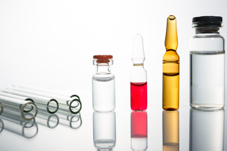 Group of vials with medication on blue methacrylate table. Horizontal composition.の写真素材