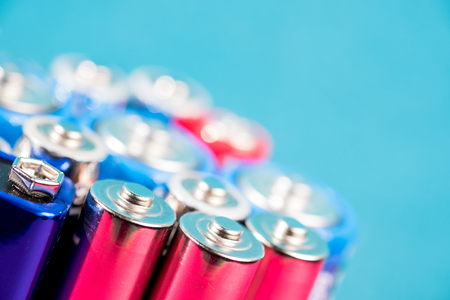 Ecology recycling concept. Many different types used or new battery, rechargeable accumulator, alkaline batteries on color background. Nature energyの写真素材