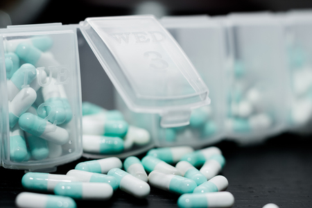 A weekly dosage of medication in pill dispenser. Selective focusの写真素材