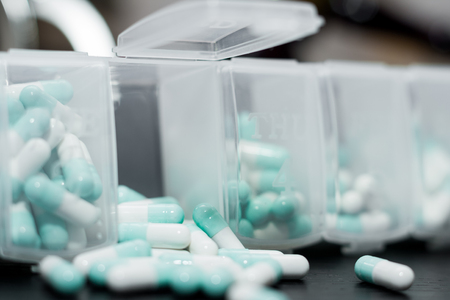 A weekly dosage of medication in pill dispenser. Selective focusの写真素材