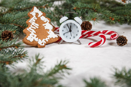 Christmas holiday background with vintage alarm-clock, Candy canes wooden background. Close-up....