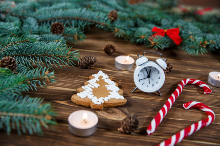 Christmas holiday background with vintage alarm-clock, Candy canes wooden background. Close-up, top view. Christmas and New Year conceptの写真素材