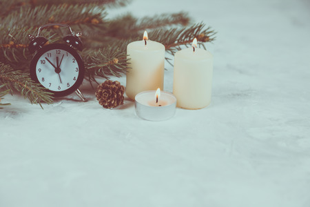 Christmas holiday background with vintage alarm-clock and candles, Candy canes plastering background. Close-up, top view. Christmas and New Year conceptの写真素材