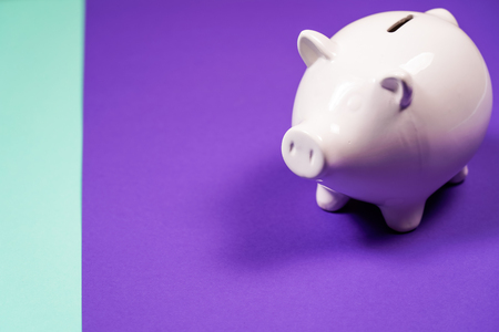 White Piggy bank isolated on purple background.の写真素材