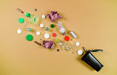Trash bins and assorted garbage isolated on green, recycle concept, Top view