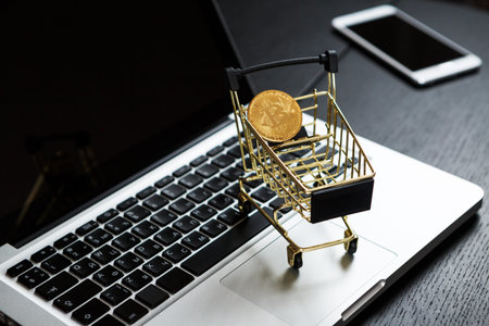 Shopping cart with bitcoin on laptop. Cryptocurrency Concept