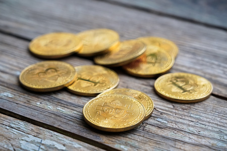 Gold Bitcoin money on wooden table. Electronic crypto currency. Business concept.の写真素材
