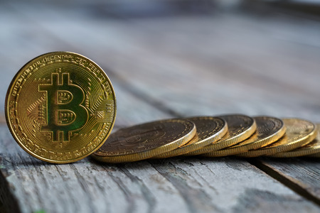 Gold Bitcoin money on wooden table. Electronic crypto currency. Business concept.の写真素材