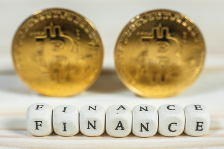 Conceptual cryptocurrency bitcoin with the word Finance on white backgroundの写真素材