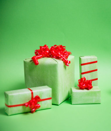 Paper Christmas gifts on green background. Christmas holidays background with copy space for your textの写真素材