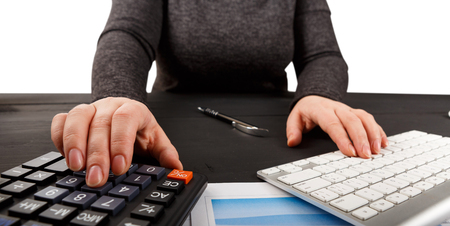Close up of female accountant or banker making calculations. Savings, finances and economy conceptの写真素材