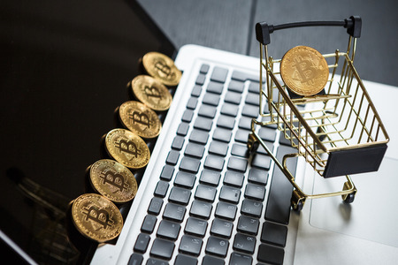 Shopping cart with bitcoin on laptop. Cryptocurrency Conceptの写真素材