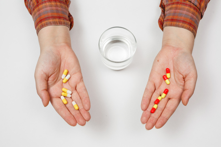 Pill in a hand isolated on white backgroundの写真素材