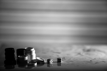 Black and white image. Checkers, dice on the bright background. Abstract background of business concept . Selective focus shallow depth field.の写真素材