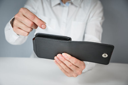 Woman hand hold and bring out card in her purse with white background