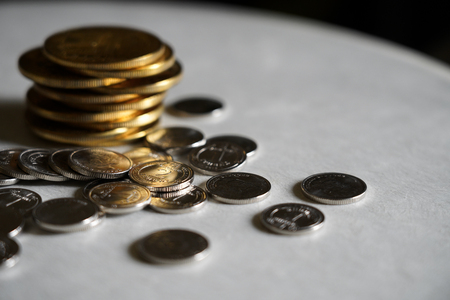 Macro shot detail of golden and silver color coin stacks on dark background with copy space for text. Business and finance growth, saving money, investment and interest concept. selective focusの写真素材