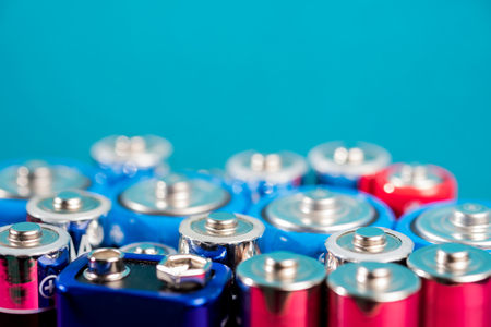 Ecology recycling concept. Many different types used or new battery, rechargeable accumulator, alkaline batteries on color background. Nature energyの写真素材