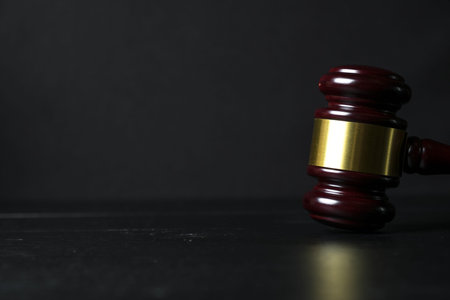 Judge gavel on black wooden background with copy space