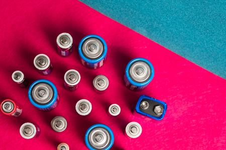Ecology recycling concept. Many different types used or new battery, rechargeable accumulator, alkaline batteries on color background. Nature energyの写真素材