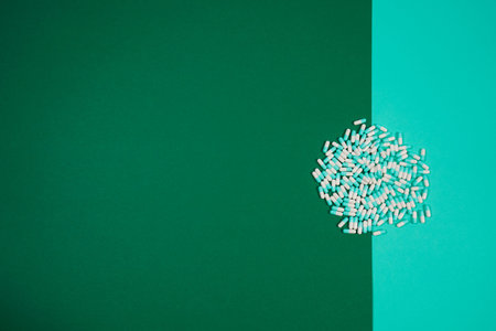 Pharmaceutical medicine pills, capsules on colored background. Copy space for textの写真素材
