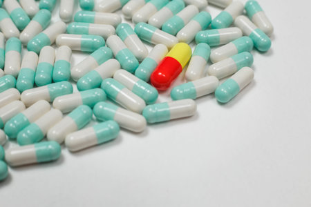 Assorted pharmaceutical medicine pills, tablets and capsules over white background