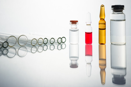 Group of vials with medication on blue methacrylate table. Horizontal composition.の写真素材