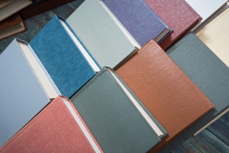 Stack books on wooden background. Back to school with copy space.の写真素材