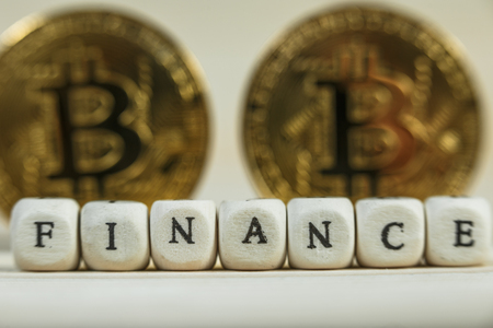Conceptual cryptocurrency bitcoin with the word Finance on white backgroundの写真素材