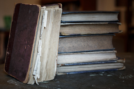 A stack of old tattered books. Vintage torn books.の写真素材