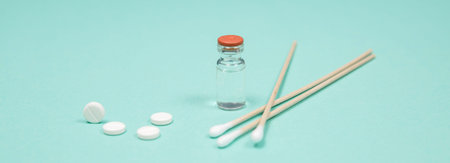 Assorted medical drugs and syringe on blue background, with copy spaceの写真素材