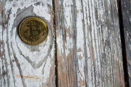 Gold Bitcoin money on wooden table. Electronic crypto currency. Business concept.