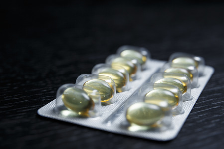 Cod liver oil omega 3 gel capsules. Vitamin D capsules. blister pack with vitamins. Pharmaceuticalの写真素材