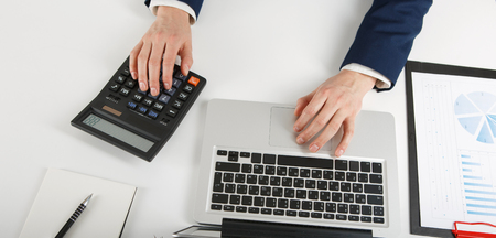 Overhead view of businessman working at computer in officeの写真素材