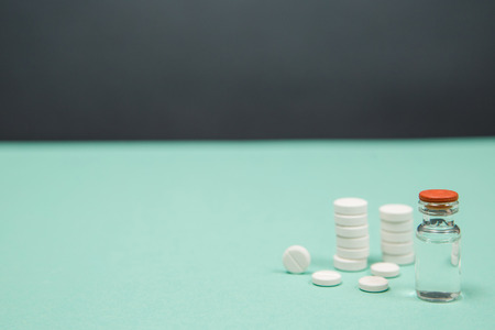 Assorted medical drugs and syringe on blue background, with copy spaceの写真素材