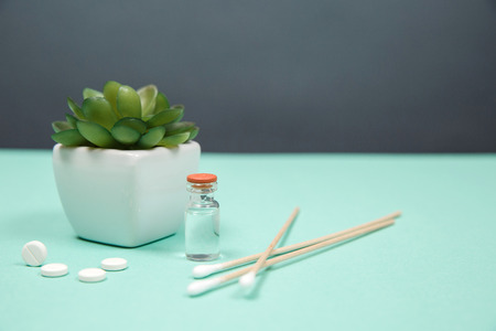 Assorted medical drugs and syringe on blue background, with copy spaceの写真素材