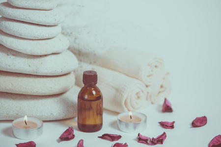 Spa still life with towels, stones, bath oil and candle. With copy spaceの写真素材