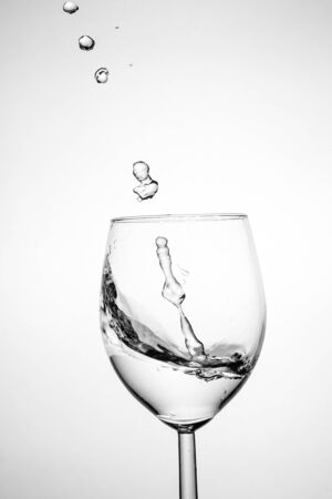Glass with water up and splash. healthy lifestyle conceptの写真素材
