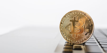 Golden Bitcoin - New virtual money on notebook. A visual representation of digital cryptocurrencies....