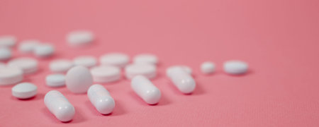 White medical pills on blue background. with a copy of space